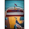 Close-up of a vintage boat's dashboard with a steering wheel and American flag, set against a blue water background.