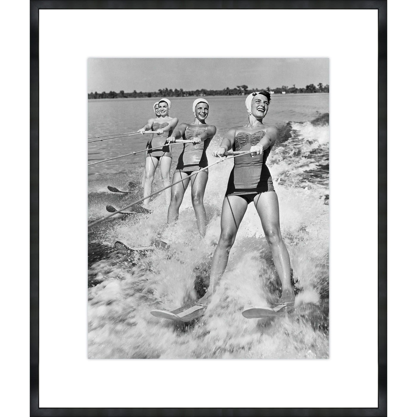 Four Young Woman Waterskiing in the Sea