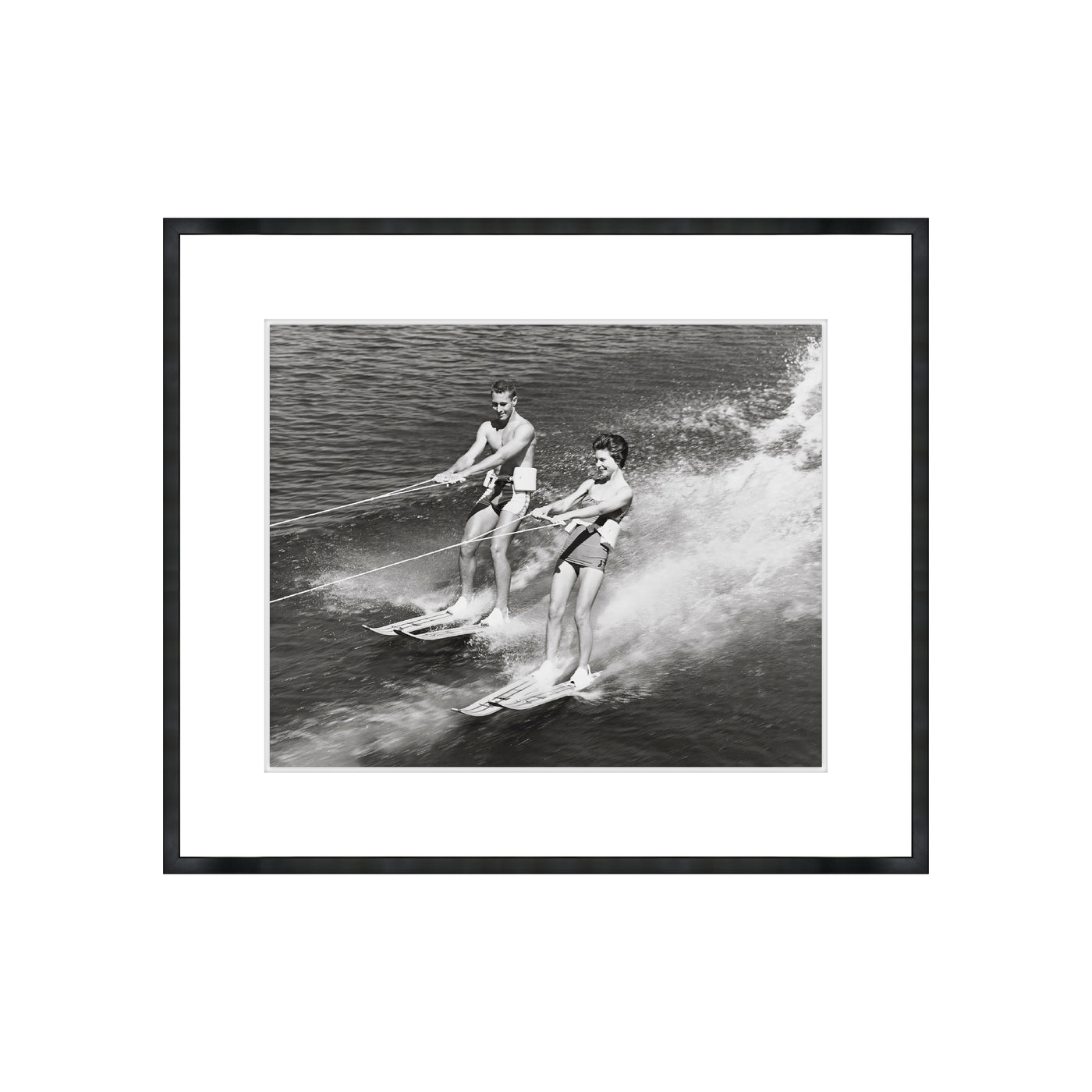 Framed black and white photograph of two people water skiing.