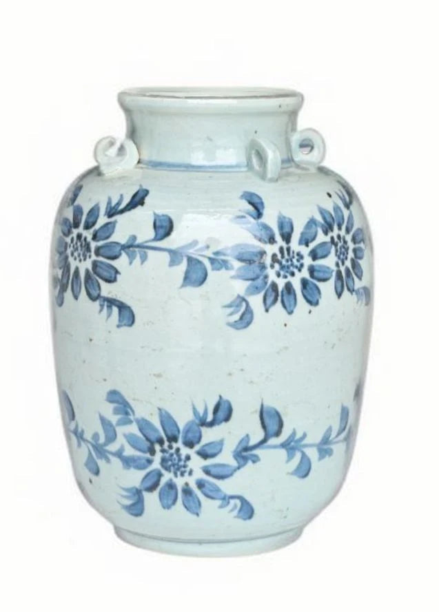 A light blue-green ceramic vase with a blue floral pattern and two loop handles on the neck, set against a plain white background.