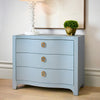 Light blue Cora curved linen chest in Harbor Mist styled in a coastal bedroom