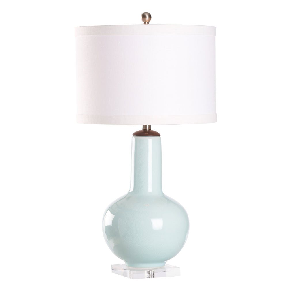 Light blue ceramic vase with white lampshade on a white background